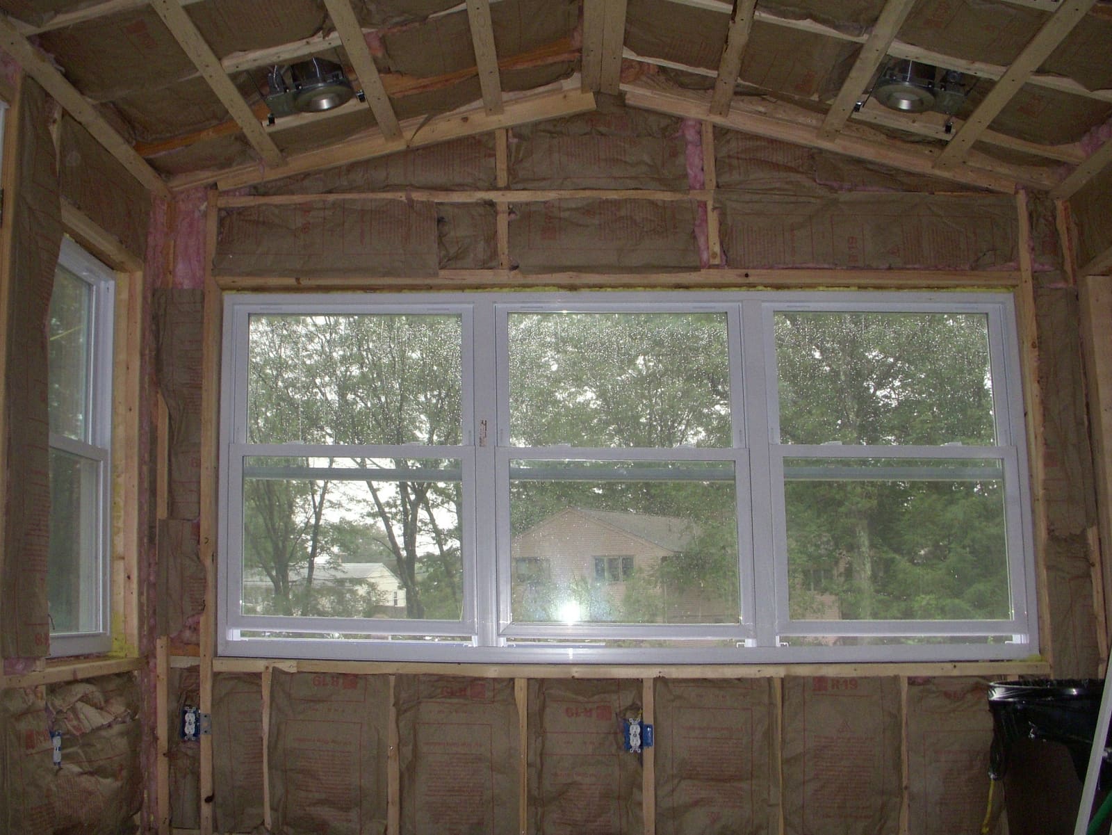 Insulated walls and ceiling framing of a home office addition before the drywall goes up.